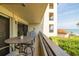 Private balcony offers views of the lush landscaping, pool, and the scenic ocean at 103 1St E St # 115, Tierra Verde, FL 33715