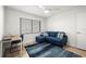 Bright room featuring a blue couch, desk, and large window for natural light at 103 1St E St # 115, Tierra Verde, FL 33715