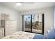 Bedroom showcasing sliding glass doors to the balcony with neighborhood and ocean views at 103 1St E St # 115, Tierra Verde, FL 33715