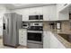 Well-appointed kitchen with stainless steel appliances, granite countertops, and ample cabinet space at 103 1St E St # 115, Tierra Verde, FL 33715