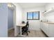 Bright office space with a modern desk, ergonomic chair, and built-in storage cabinets at 103 1St E St # 115, Tierra Verde, FL 33715