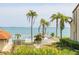 Community pool area with palm trees overlooking the bay offers a relaxing atmosphere at 103 1St E St # 115, Tierra Verde, FL 33715