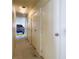 Hallway in parking garage featuring white storage units numbered 201 at 103 1St E St # 115, Tierra Verde, FL 33715