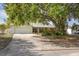 Charming single-story home featuring an attached two-car garage, mature trees, and a well-maintained lawn at 103 W Anglewood Dr, Brandon, FL 33511