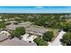 A beautiful aerial view of a townhome community bordered by lush landscaping and a distant cityscape at 10418 Tulip Field Way, Riverview, FL 33578
