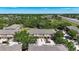 A panoramic aerial view showcases multiple townhomes surrounded by lush greenery and beautiful ponds at 10418 Tulip Field Way, Riverview, FL 33578