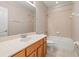 Bright bathroom features a vanity with a large mirror and a combined shower and tub at 10418 Tulip Field Way, Riverview, FL 33578
