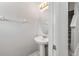 Cozy half-bathroom with pedestal sink and decorative light fixture near carpeted stairs at 10418 Tulip Field Way, Riverview, FL 33578