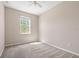 Bedroom with neutral carpet, ceiling fan, and a sun-filled window creating a calming atmosphere at 10418 Tulip Field Way, Riverview, FL 33578