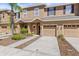 Charming townhouse with an attached garage, well-manicured lawn, and lovely front yard landscaping at 10418 Tulip Field Way, Riverview, FL 33578