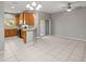 Eat-in kitchen with wood cabinets, black appliances, bar seating and sliding door to outdoor area at 10418 Tulip Field Way, Riverview, FL 33578