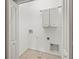 Dedicated laundry room with storage cabinets and hook-ups for washer and dryer at 10418 Tulip Field Way, Riverview, FL 33578