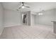Open floor plan with large tile flooring and fan, connecting kitchen, dining, and living area at 10418 Tulip Field Way, Riverview, FL 33578