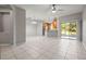 Open concept living and dining area with tile floors, ceiling fan, and sliding door to patio at 10418 Tulip Field Way, Riverview, FL 33578
