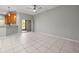 Spacious living room featuring tile floors, neutral paint, a ceiling fan, and sliding glass doors at 10418 Tulip Field Way, Riverview, FL 33578