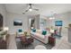 Bright living and dining area featuring modern furnishings, neutral tones, and abundant natural light at 10418 Tulip Field Way, Riverview, FL 33578