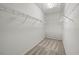 Empty walk-in closet with shelving, hanging rods, and carpet flooring at 10418 Tulip Field Way, Riverview, FL 33578
