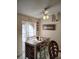 Cozy dining area with a wooden table, comfortable seating, and a bright window enhancing the space at 1061 6Th Nw St, Largo, FL 33770