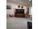 Bright living room with white tile floors, ceiling fan, modern decor, and large entertainment center at 1061 6Th Nw St, Largo, FL 33770