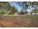 Spacious backyard showing a screened-in patio and mature trees at 11347 Amboy St, Spring Hill, FL 34609