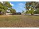 Large backyard featuring a screened-in patio and a white privacy fence at 11347 Amboy St, Spring Hill, FL 34609