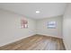 Bright bedroom featuring wood-look floors and a large window at 11347 Amboy St, Spring Hill, FL 34609
