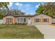 Charming single-story home with natural wood accents, complemented by a well-maintained lawn at 11347 Amboy St, Spring Hill, FL 34609