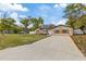 Charming single-story home featuring a well-manicured lawn and a long driveway at 11347 Amboy St, Spring Hill, FL 34609