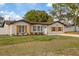 Charming home exterior with manicured lawn, complemented by natural wood shutters and accents at 11347 Amboy St, Spring Hill, FL 34609