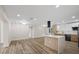 Open floor plan showcasing a modern kitchen with quartz countertops and wood-look flooring at 11347 Amboy St, Spring Hill, FL 34609