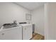 Bright laundry area features modern washer, dryer, sink, and storage at 11347 Amboy St, Spring Hill, FL 34609