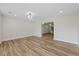 Open-concept living room with hardwood floors, neutral paint, and a modern chandelier at 11347 Amboy St, Spring Hill, FL 34609