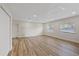 Open living room area features wood flooring, recessed lighting, and a bright, neutral color palette at 11347 Amboy St, Spring Hill, FL 34609