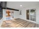 Bright living space boasts wood-look flooring, with access to the pool and kitchen area through sliding doors at 11347 Amboy St, Spring Hill, FL 34609