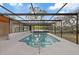 Enclosed pool features a screen enclosure with clear roof panels, providing a bright and airy swimming experience at 11347 Amboy St, Spring Hill, FL 34609