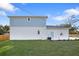Exterior shot of the house with a well-kept green lawn and partial fence at 11598 Oak Ln, Largo, FL 33778