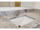 Bathroom featuring gray and white speckled granite countertop, stylish chrome faucet, and modern rectangular sink at 11598 Oak Ln, Largo, FL 33778