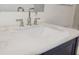 Bathroom featuring blue vanity, marble countertop, undermount sink and modern chrome faucet and handles at 11598 Oak Ln, Largo, FL 33778