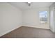 Cozy bedroom with neutral carpet and a window providing natural light at 11598 Oak Ln, Largo, FL 33778