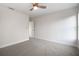 Bedroom featuring neutral carpet, a ceiling fan, and a doorway to another room at 11598 Oak Ln, Largo, FL 33778