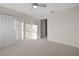 Bright, carpeted bedroom features a ceiling fan and a closet, providing ample storage space at 11598 Oak Ln, Largo, FL 33778