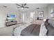 Bright bedroom featuring a ceiling fan, neutral colors, and an ensuite bath at 11598 Oak Ln, Largo, FL 33778