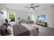 Bright bedroom with a ceiling fan, neutral colors, and large windows overlooking the yard at 11598 Oak Ln, Largo, FL 33778