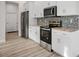 Well-appointed kitchen with stainless steel appliances, granite counters, and ample cabinetry at 11598 Oak Ln, Largo, FL 33778