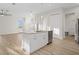 Modern kitchen island features a stainless steel dishwasher and a sink at 11598 Oak Ln, Largo, FL 33778