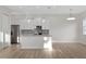 Open-concept kitchen with stainless steel appliances and a large island at 11598 Oak Ln, Largo, FL 33778