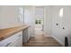 Hallway leading into laundry room with wood counter and view of kitchen at 11598 Oak Ln, Largo, FL 33778