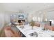 Open-concept living and dining area, flooded with light and featuring hardwood floors and modern decor at 11598 Oak Ln, Largo, FL 33778