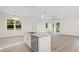 Open concept living space with pendant lighting and hardwood flooring throughout at 11598 Oak Ln, Largo, FL 33778