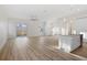 Open-concept living area with modern wood flooring, neutral walls, and natural light at 11598 Oak Ln, Largo, FL 33778